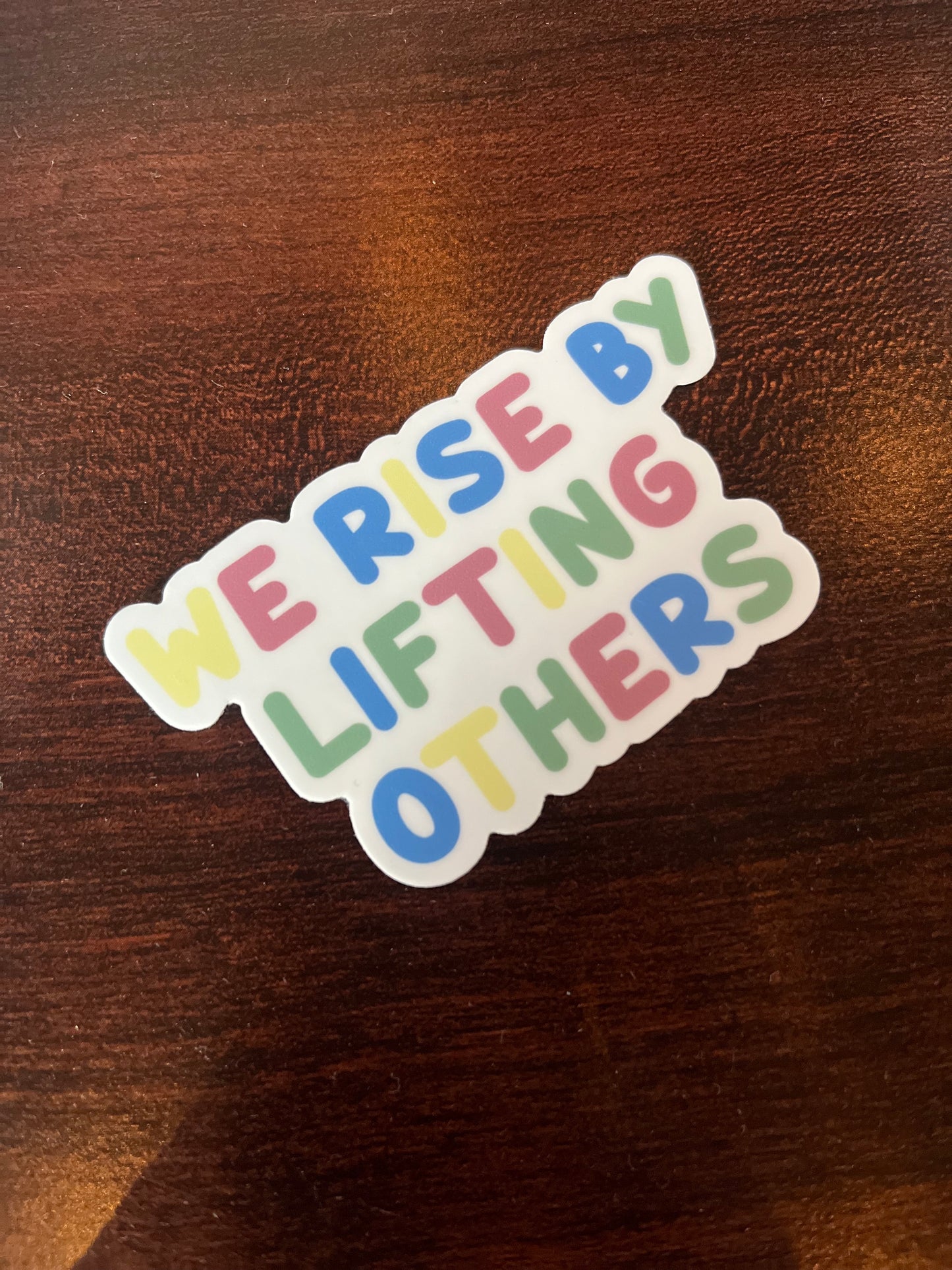 WE RISE sticker